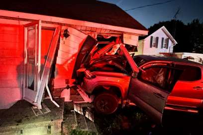 Driver Charged After Crashing Into House